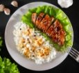 teriyaki-chicken-with-sesame-seeds-lettuce-and-ric-UR9S6HA.jpg